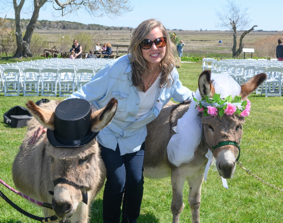 A Latham Friend takes photo with two-donkeys dressed for a "wedding."